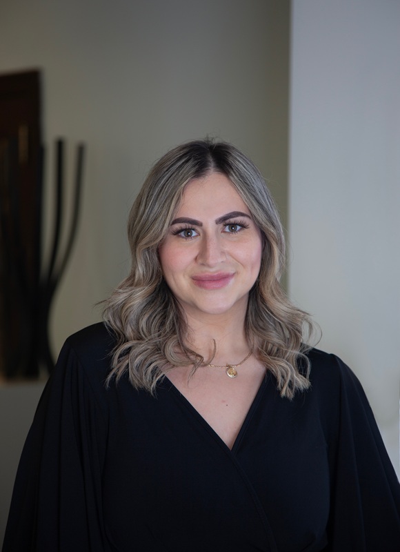 Portrait of Mayra | Office Manager smiling in professional attire