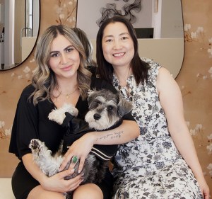 Dental office team members posing together with a dog